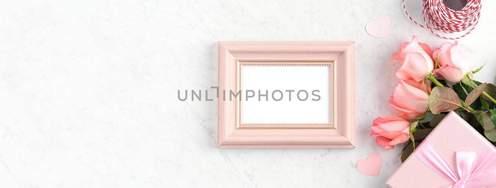 Giftbox and pink rose flower on marble white table background for Mother's Day holiday greeting design concept.