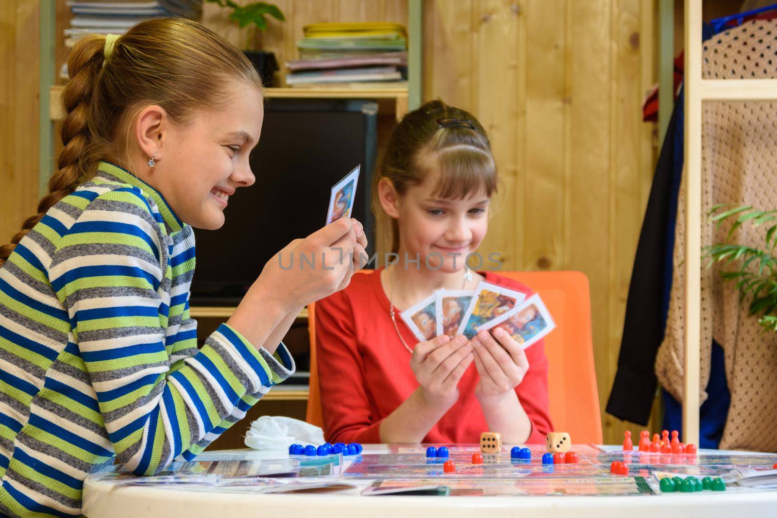 Happy kids playing board games