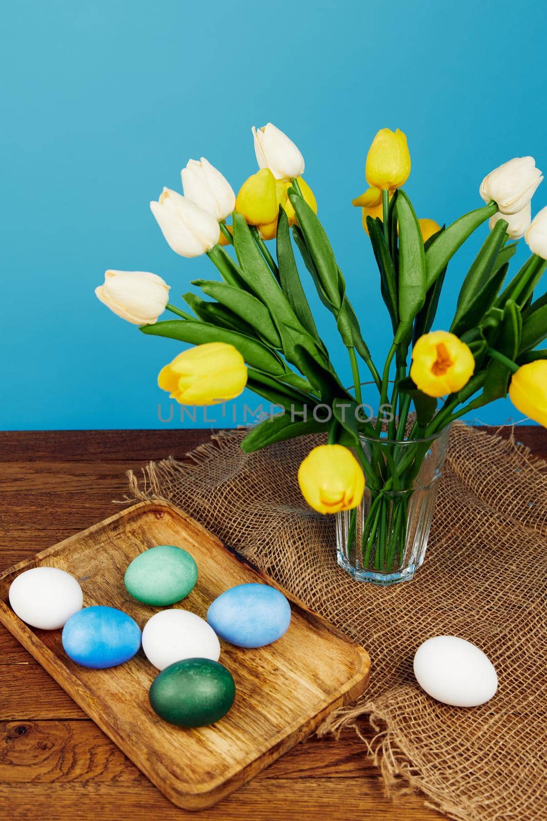tulip bouquet easter eggs tradition blue background. High quality photo