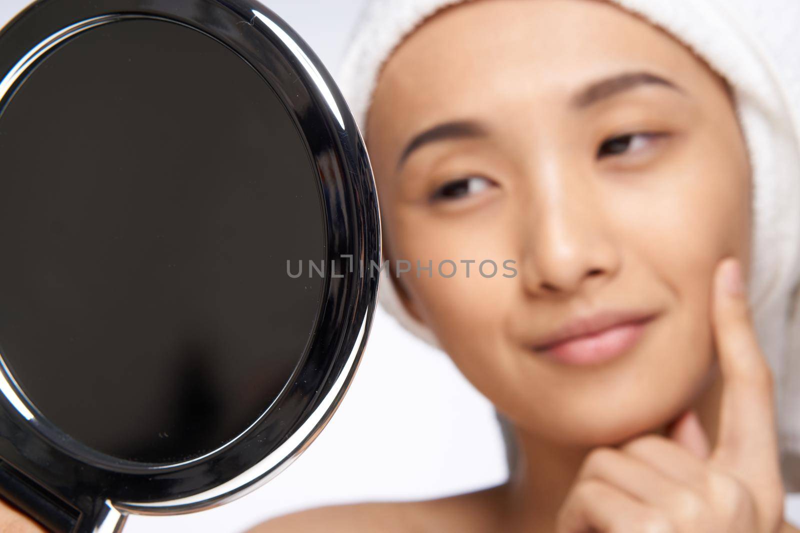 pretty woman looking in the mirror healthy skin rejuvenation spa treatments. High quality photo
