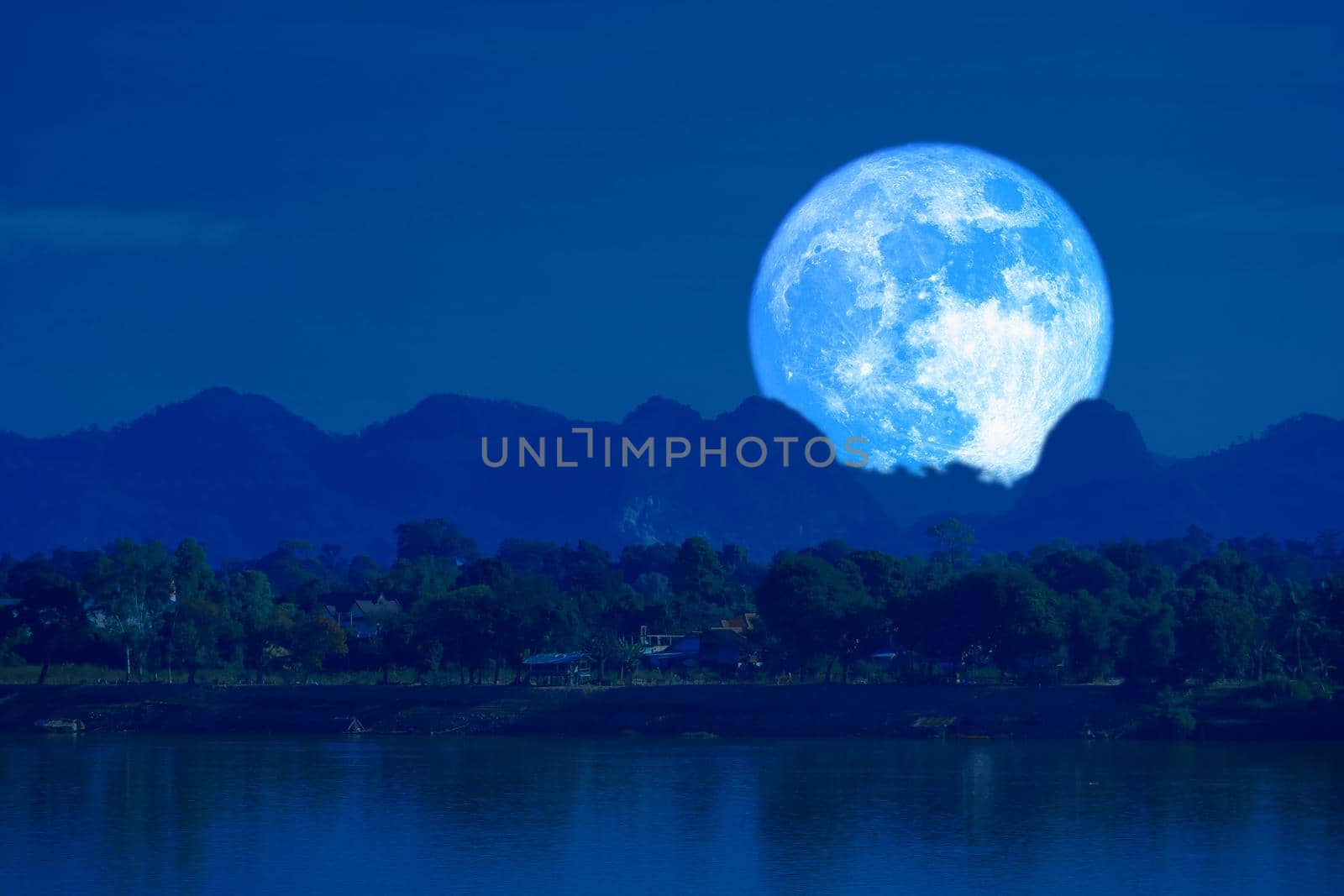 full blue worm blue moon rise back silhouette mountain blur dark cloud on the night sky by Darkfox