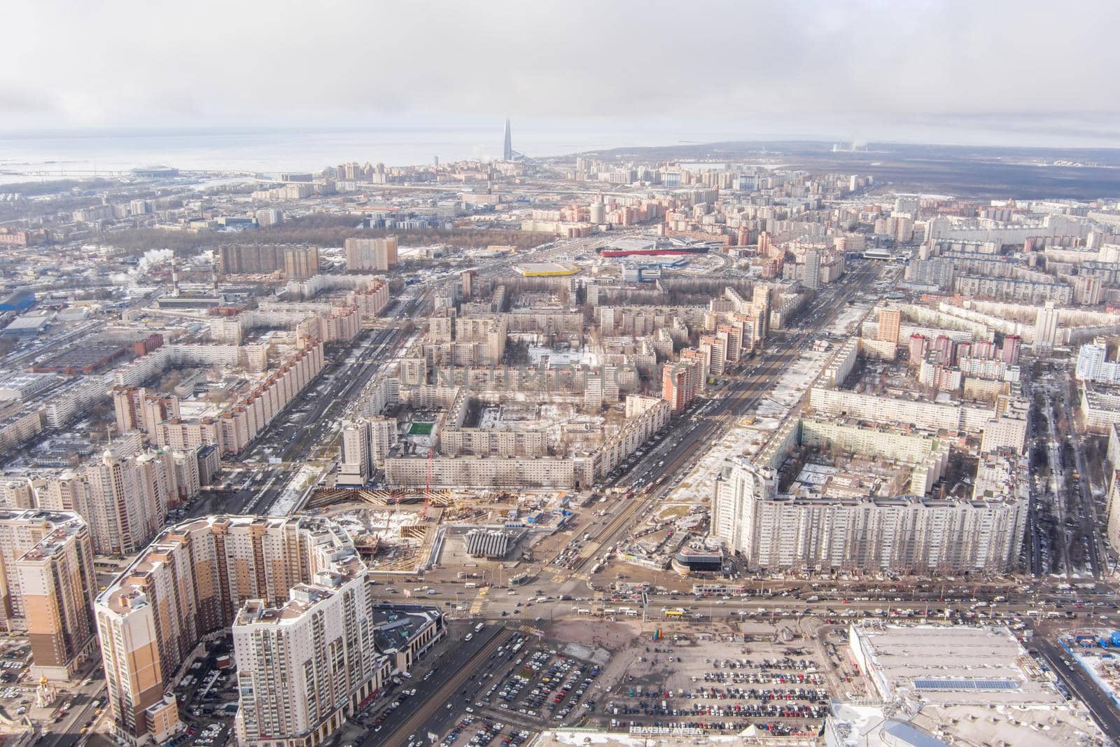 Russia, St.Petersburg, 03 March 2021: The Aerial view of the huge crossroad at metro station Pioneerskaya, Ispytateley Avenue and Kolomyazhsky, huge houses, developing shopping center. High quality image