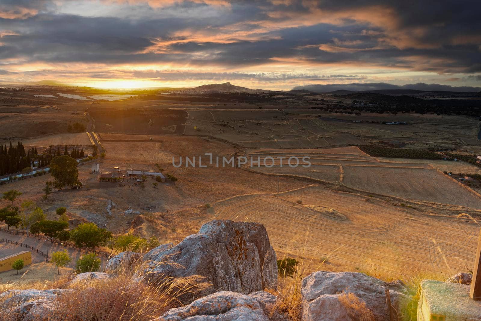 Small Andalusian town in southern Spain photographed from the top of a mountain with clouds