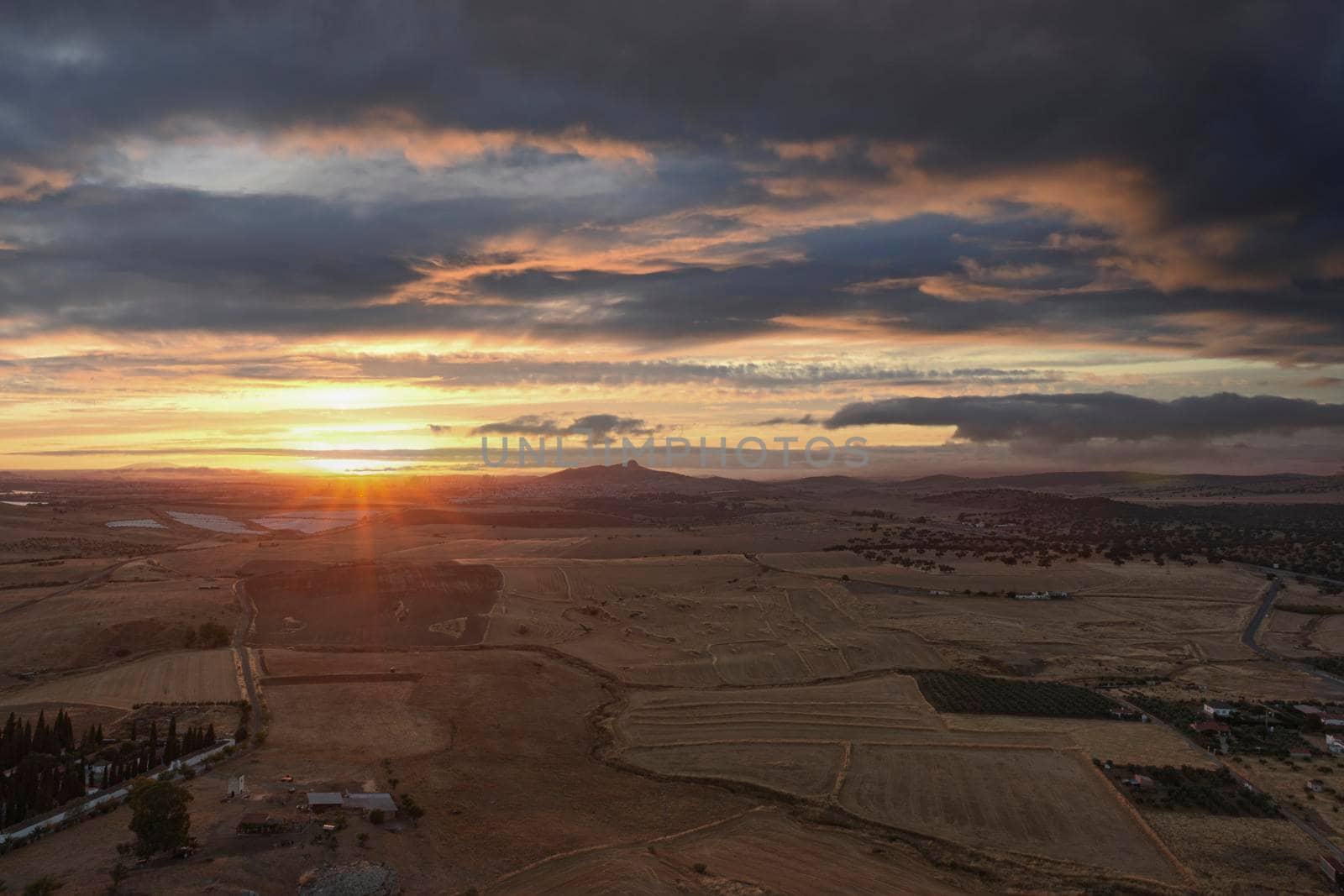 Small Andalusian town in southern Spain photographed from the top of a mountain with clouds