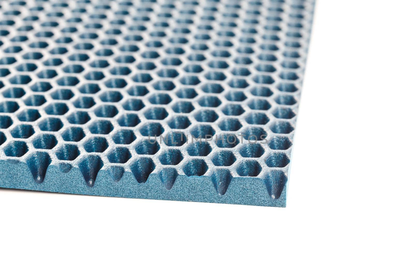 blue hexagonal punched EVA - ethylene vinyl acetate foam carpet linear perspective background with selective focus.