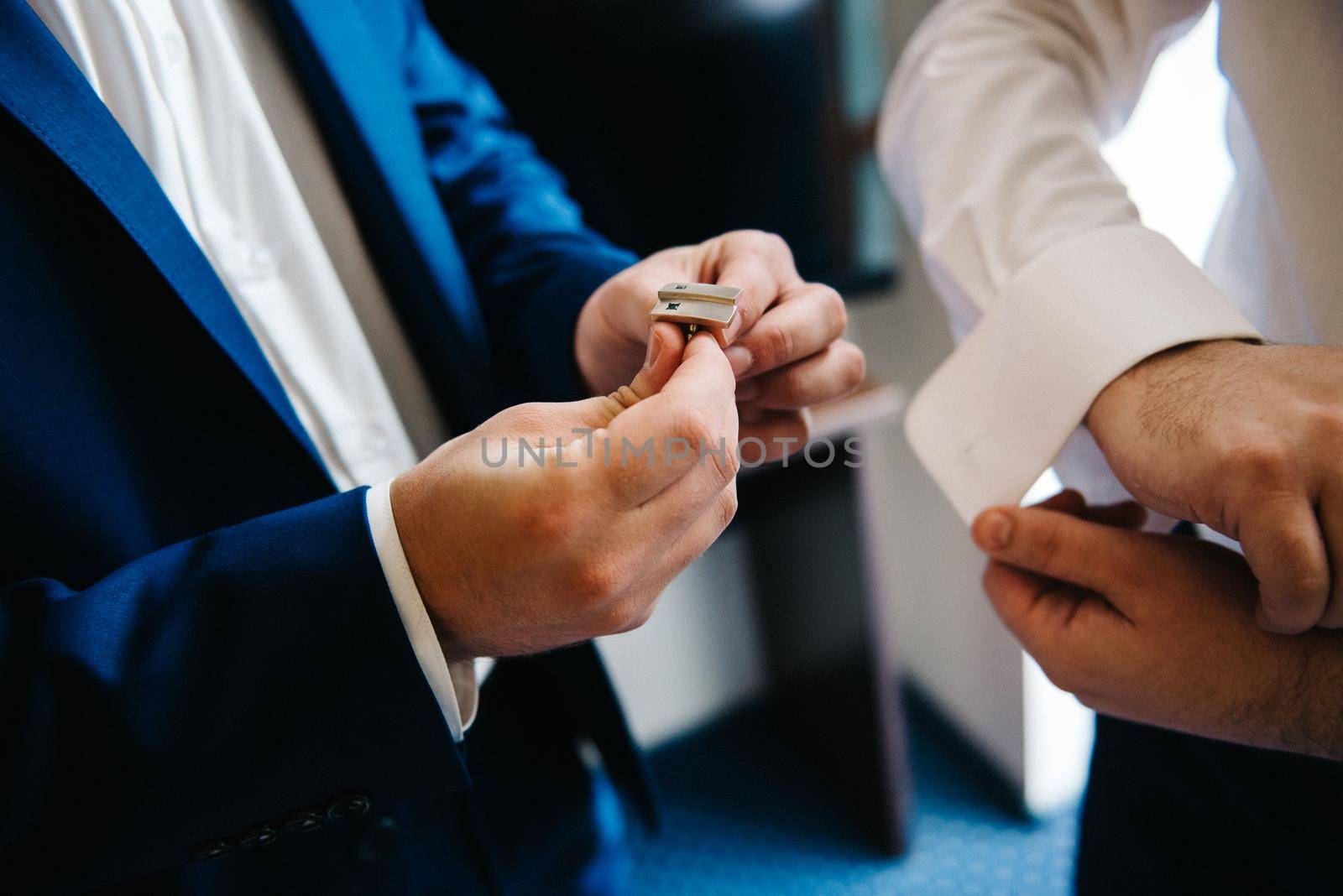 the bride and groom tenderly hold hands between them love and relationships by Andreua