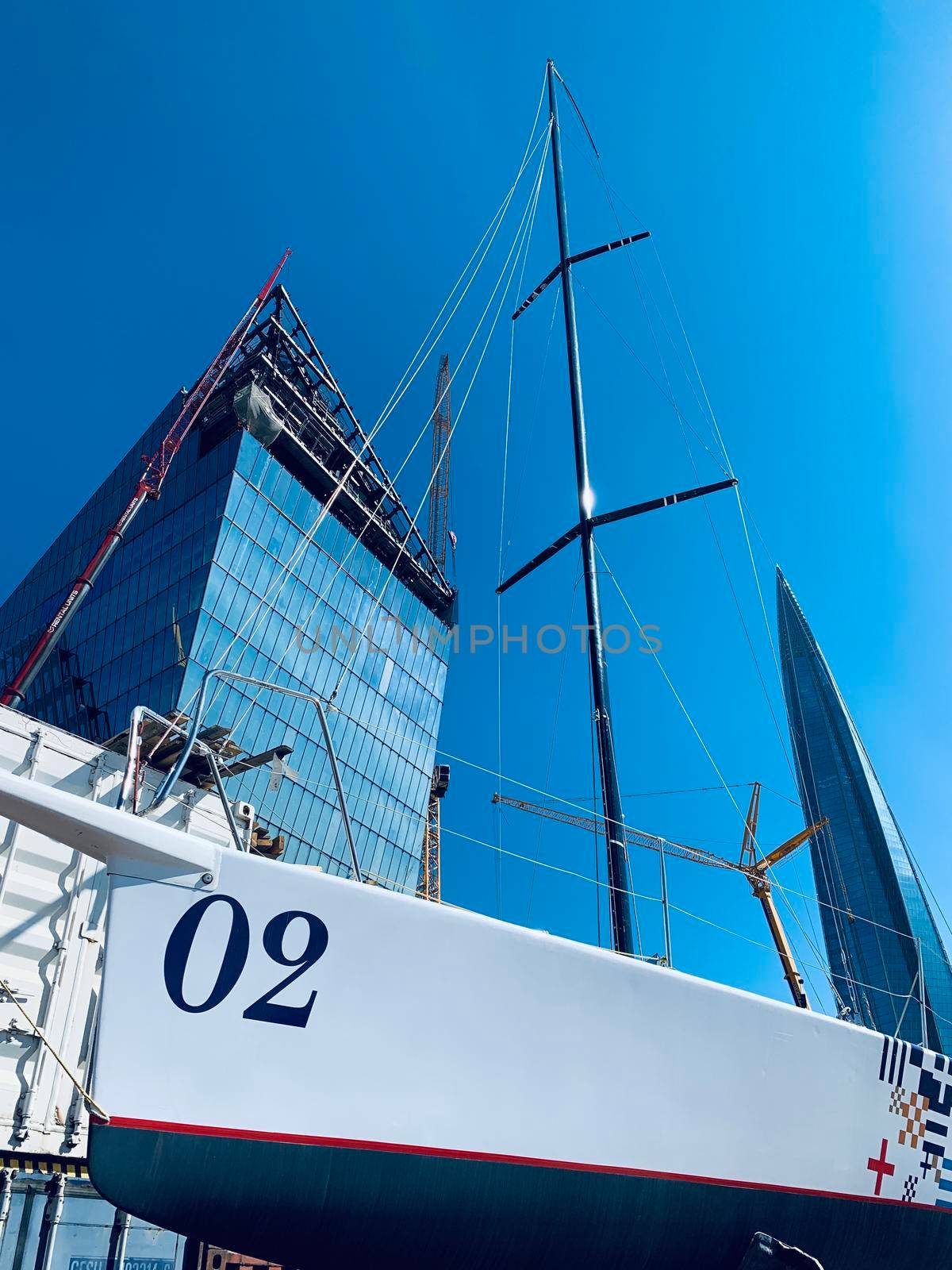 Russia, St.Petersburg, 26 May 2020: Port Hercules, the sailboats stand on supports, the bottom view, masts and the slings, a clear sunny weather, the blue sky, the bottom of the boat and kiel by vladimirdrozdin