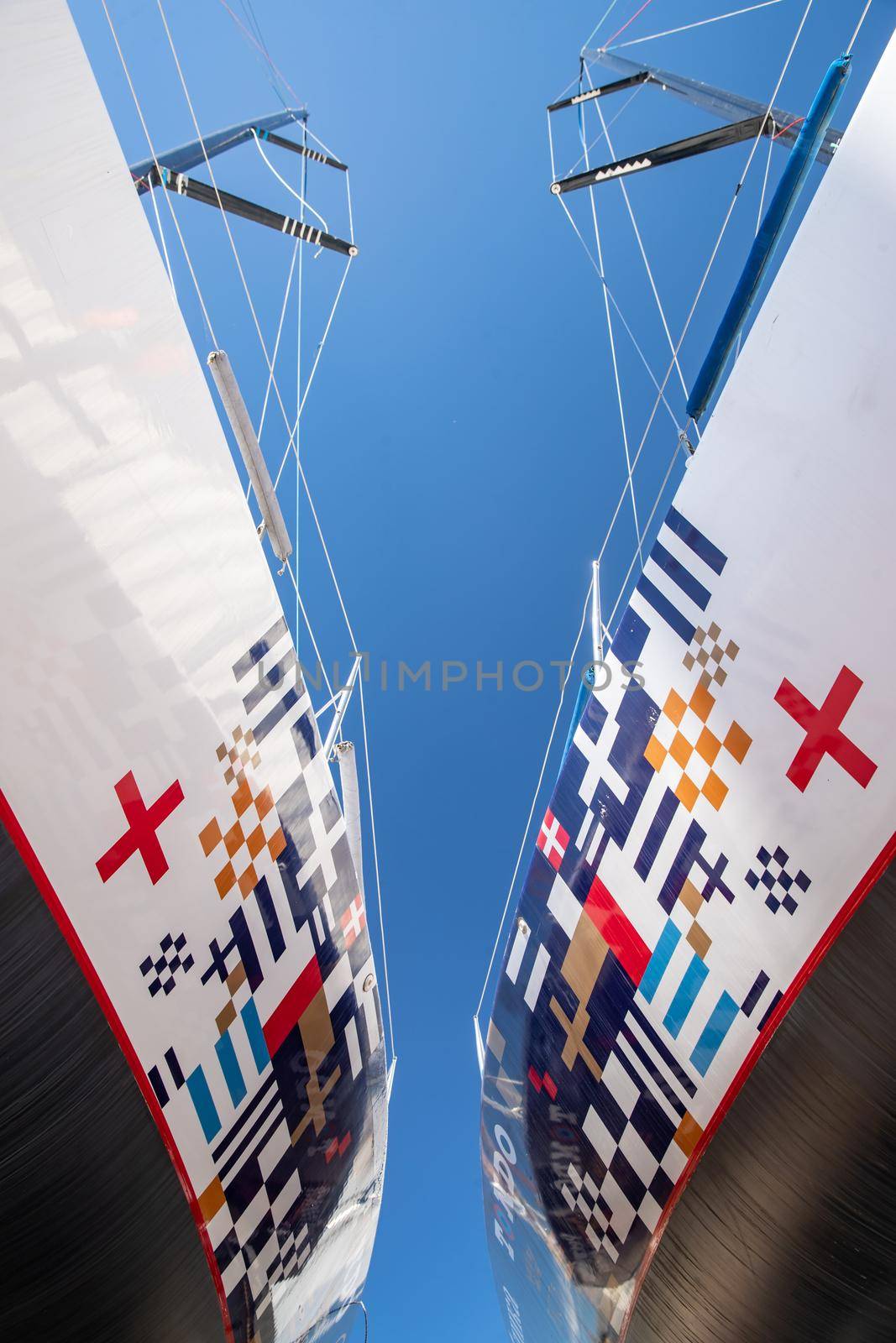 Russia, St.Petersburg, 26 May 2020: Port Hercules, the sailboats stand on supports, the bottom view, masts and the slings, a clear sunny weather, the blue sky, the bottom of the boat and kiel, logo