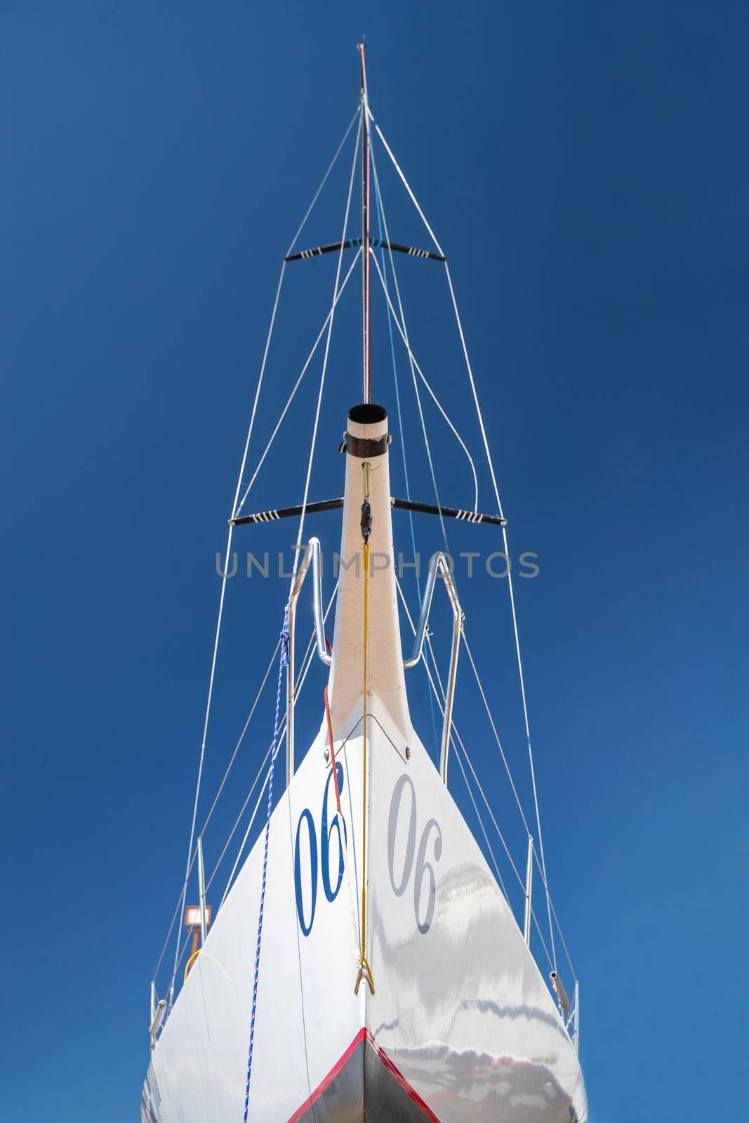 Russia, St.Petersburg, 26 May 2020: Port Hercules, the sailboats stand on supports, the bottom view, masts and the slings, a clear sunny weather, the blue sky, the bottom of the boat and kiel by vladimirdrozdin