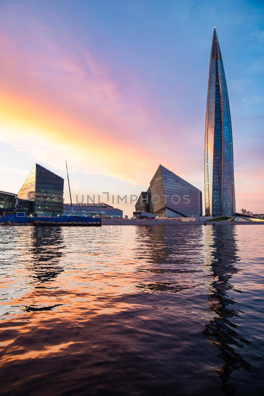 Russia, St.Petersburg, 03 July 2020: The color image of skyscraper Lakhta center at sunset, Reflection of the sunset sky in a glass facade of the building, It is the highest skyscraper in Europe by vladimirdrozdin