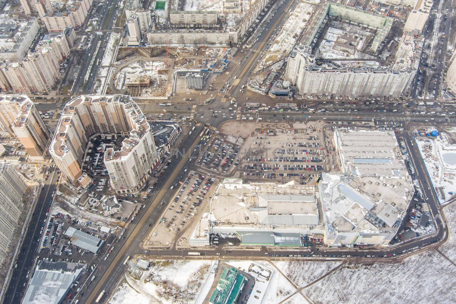 The Aerial view of the huge crossroad at subway station Pioneerskaya, Ispytateley Avenue and Kolomyazhsky, huge houses, developing shopping center, car parking by vladimirdrozdin