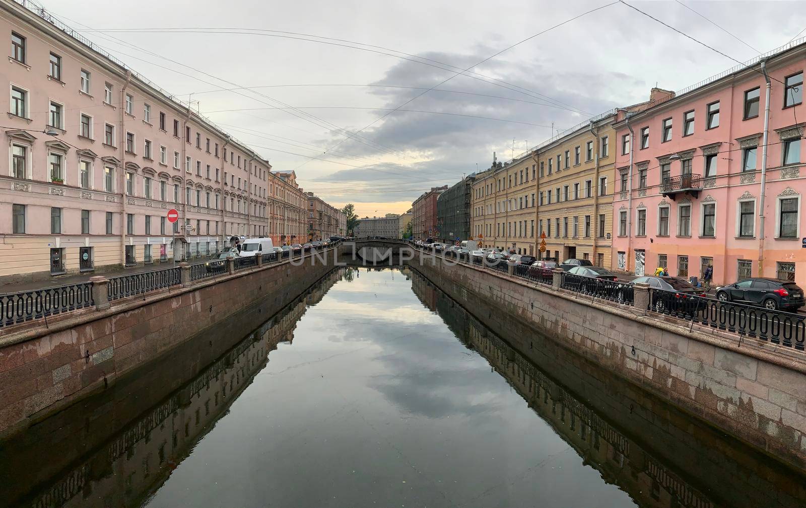 Russia, St.Petersburg, 09 June 2020: Griboyedov Canal at sunset, specular reflection in water, architecture of St. Petersburg, the bridge through the river by vladimirdrozdin