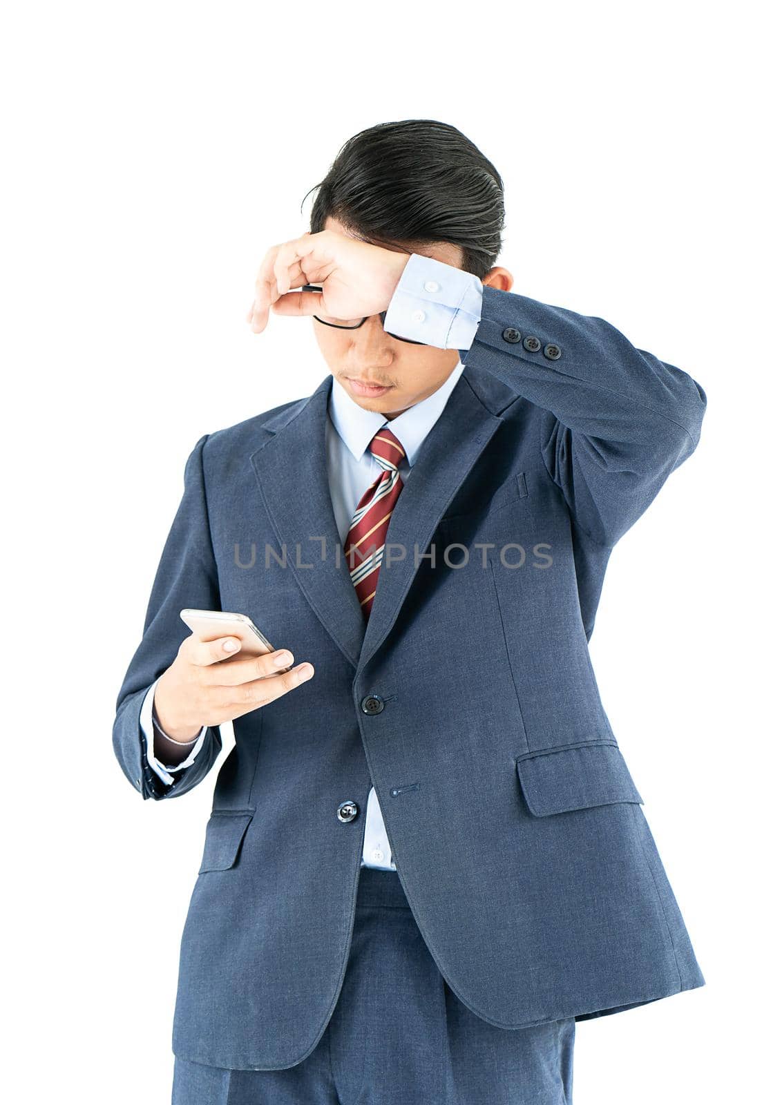Businessman in suit holding a smartphone over white background