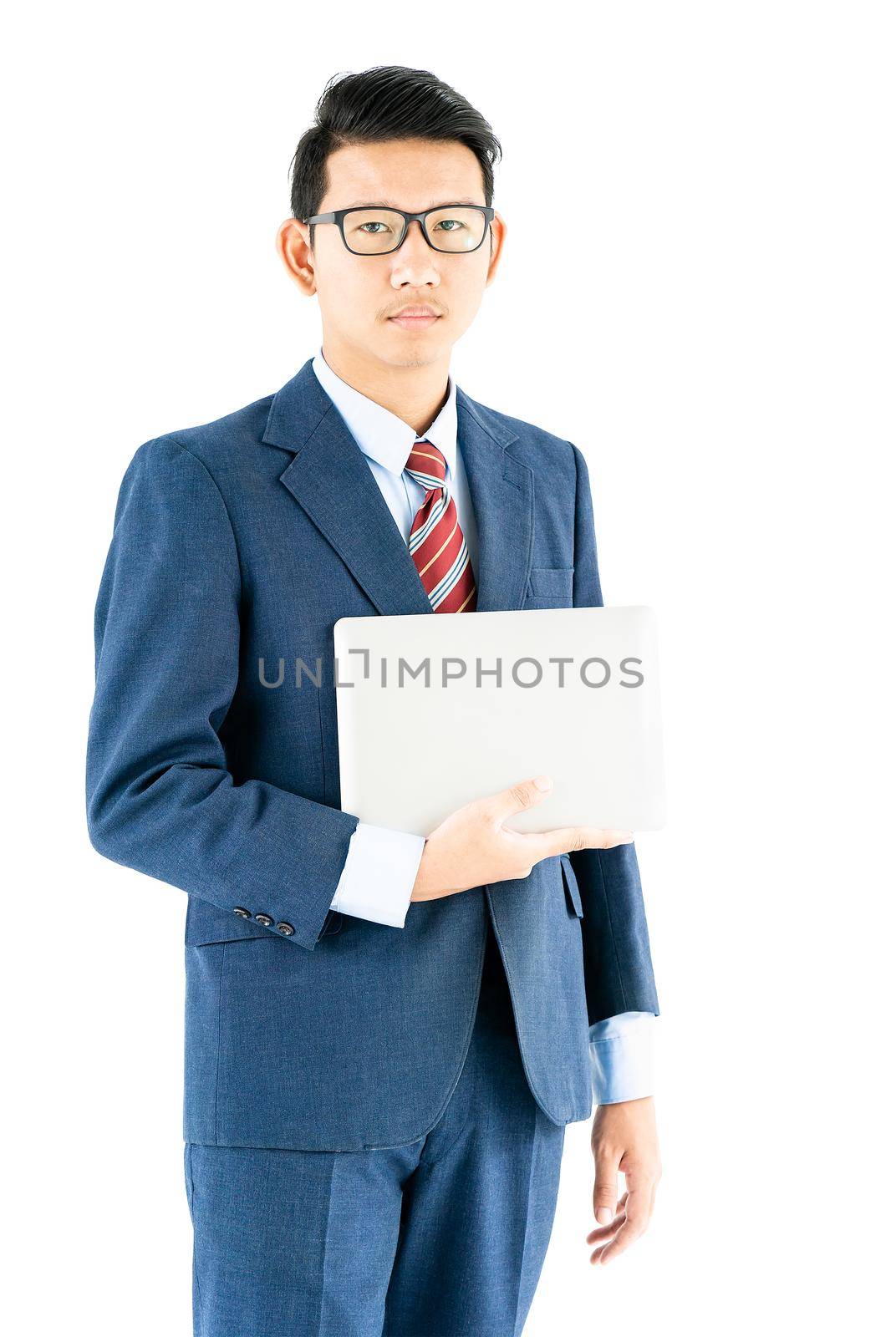 Young asian businessman portrait in suit and wear glasses holding a laptop over white background