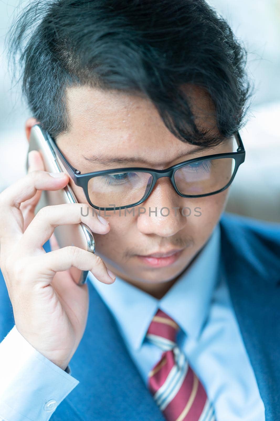 Businessman talking on the phone in car by stoonn