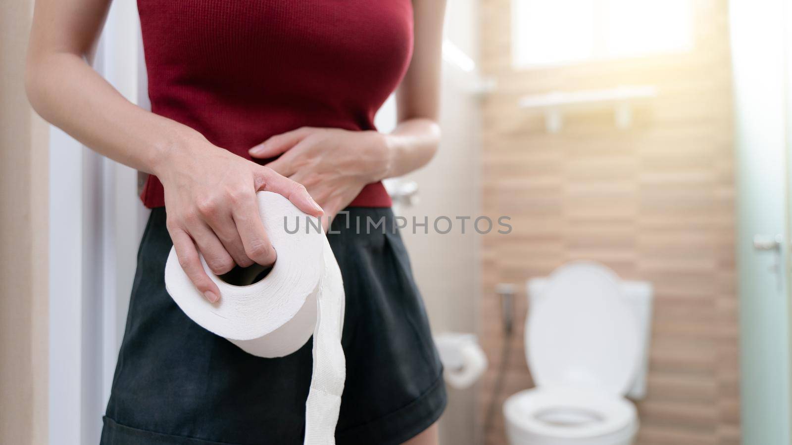 woman with toilet paper, stomachache diarrhea symptom, menstrual period cramp or food poisoning. Health care concept. by sirawit99