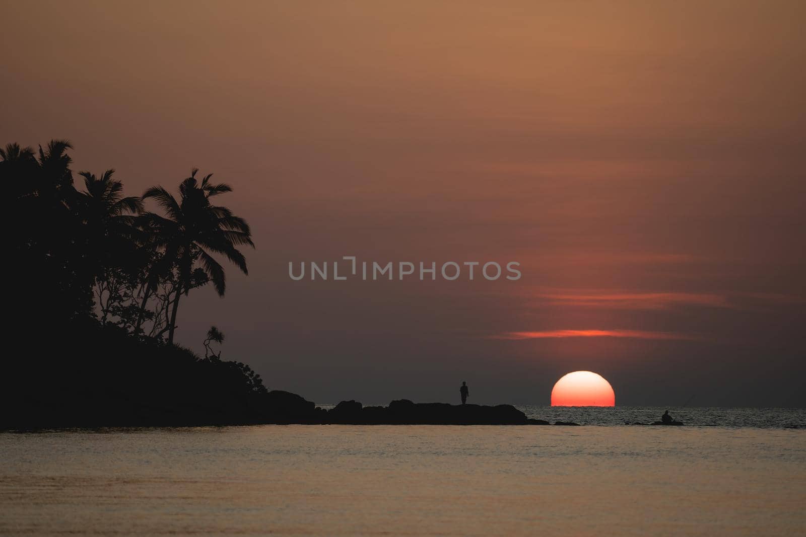 Sunset ocean view. Sun above the sea on orange sky. by sirawit99