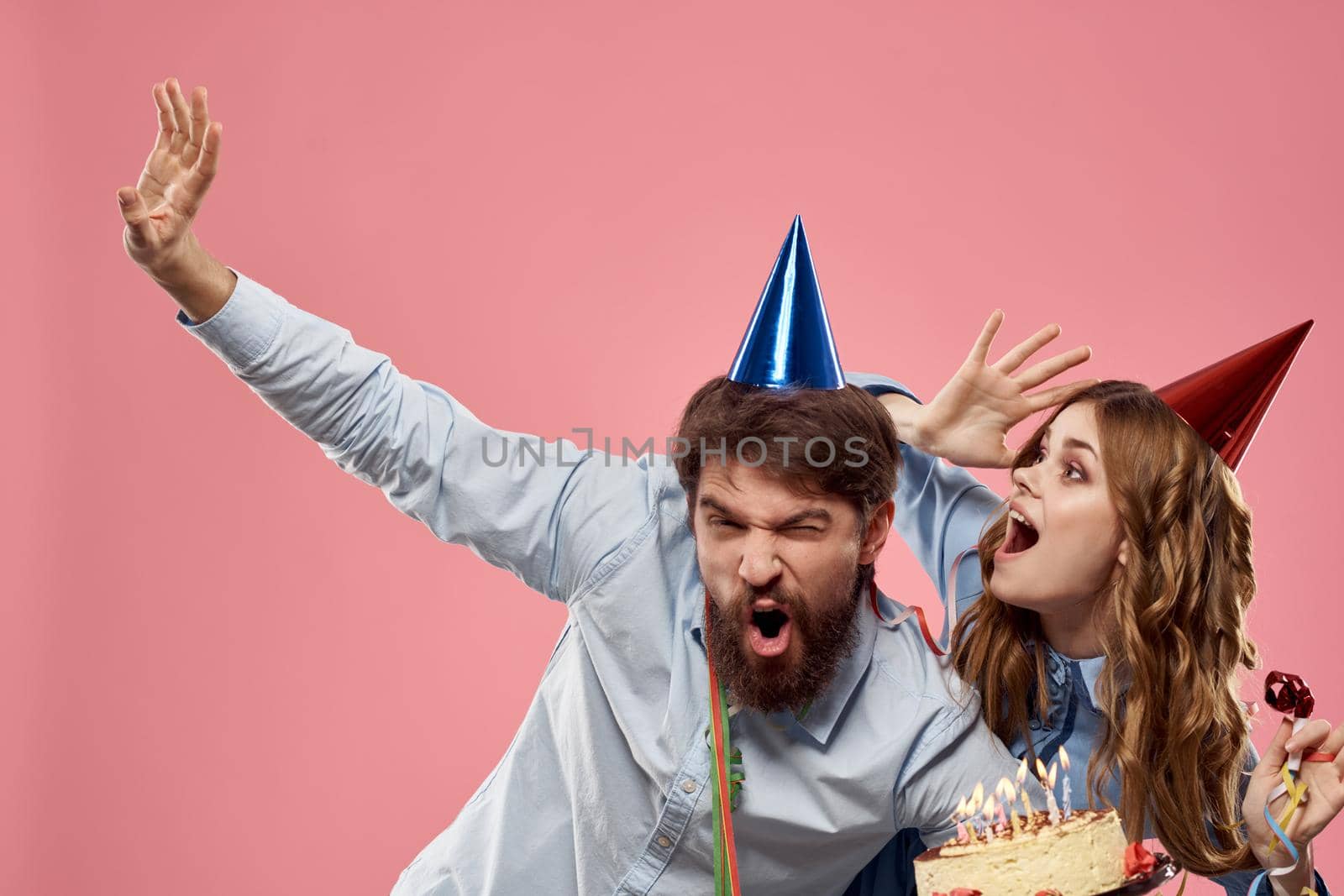 Party man and woman corporate pink background fun cake cap. High quality photo