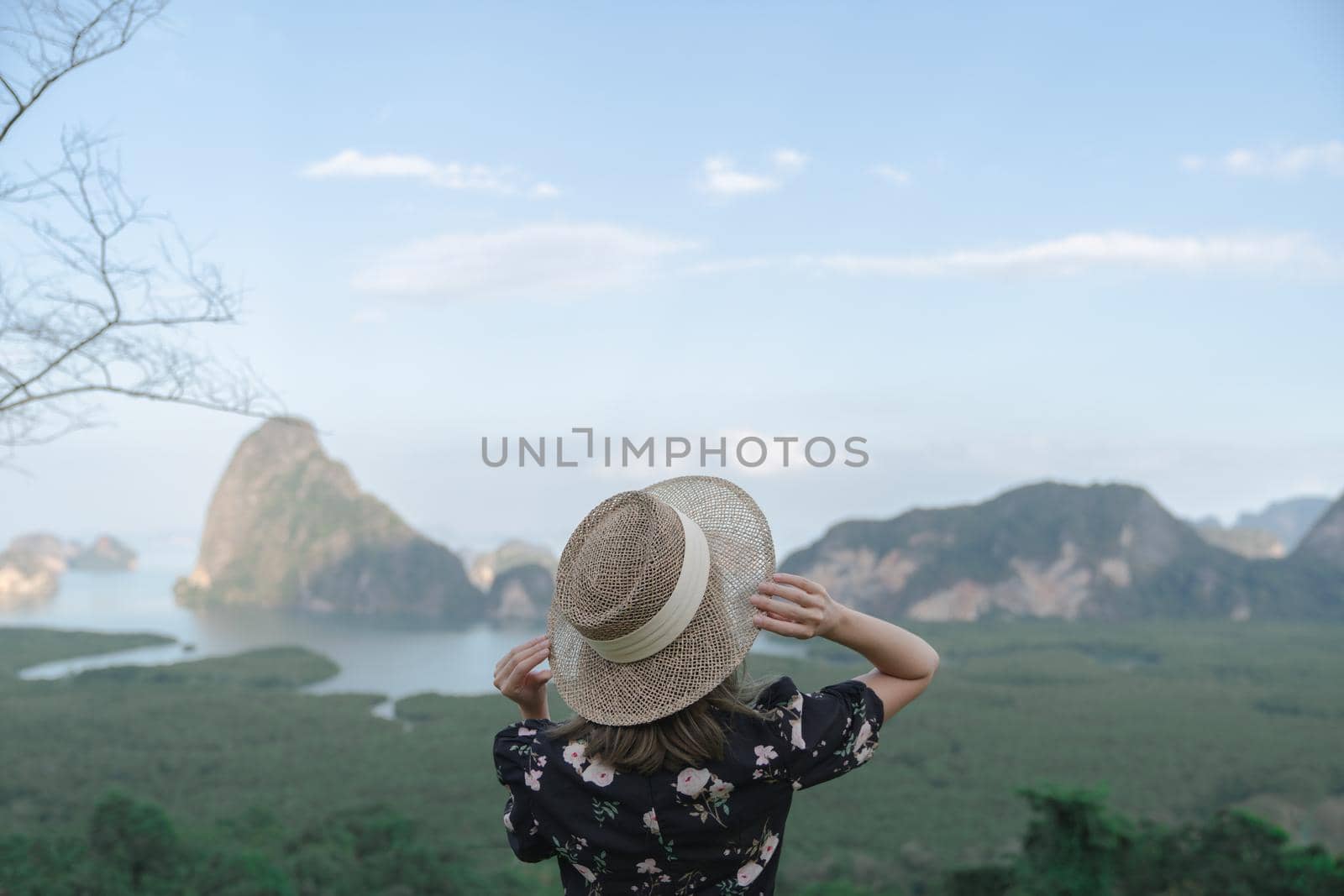 Samed Nang Chee. Woman with view of the Phang Nga bay, mangrove tree forest and hills at Andaman sea, Thailand. by sirawit99