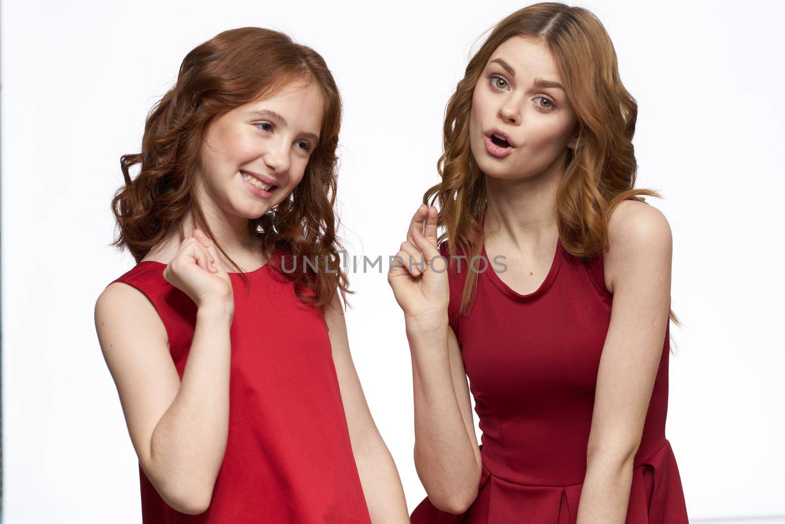 Joyful family fun mom daughter emotions light background. High quality photo