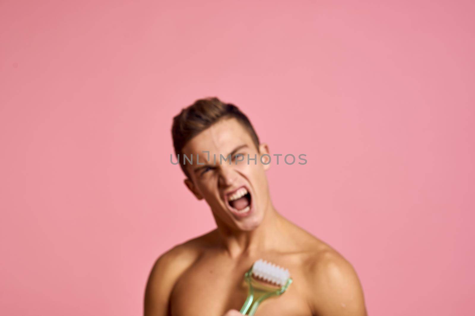 Cute man naked shoulders skin care hygiene pink background by SHOTPRIME