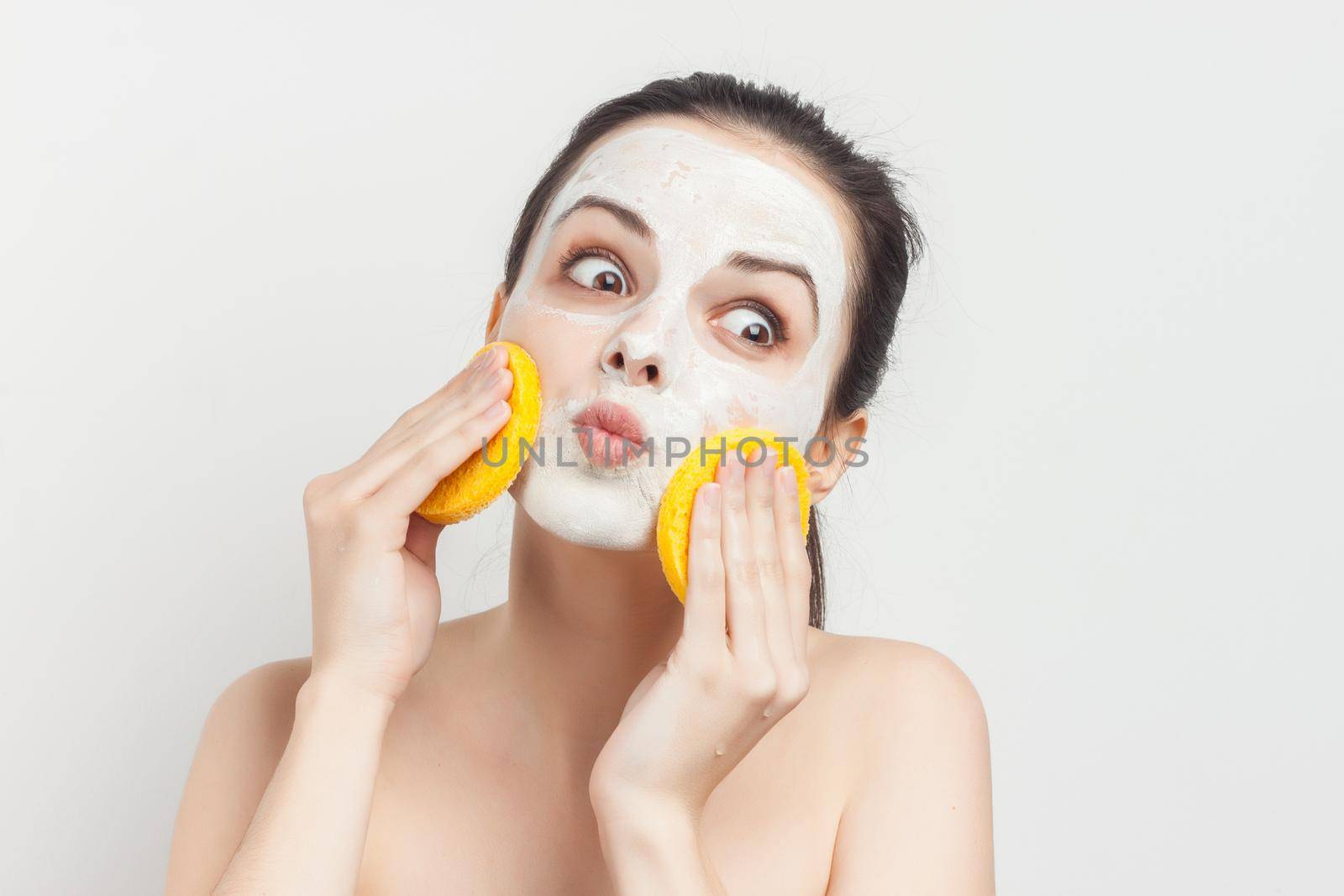 brunette with face mask naked shoulders skincare. High quality photo
