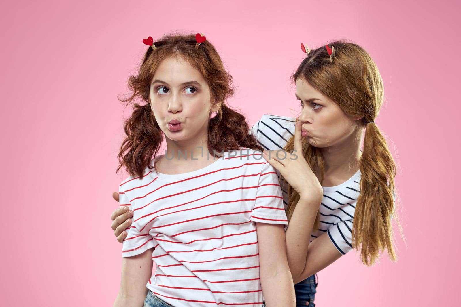 cheerful girl and woman on a pink background sisters family emotions by SHOTPRIME