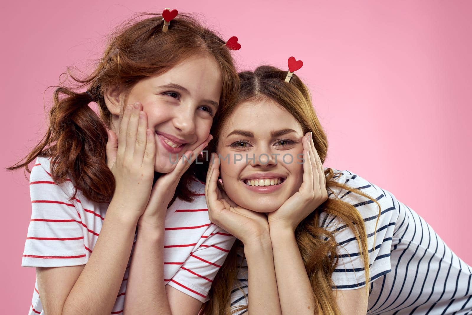 cheerful girl and woman on a pink background sisters family emotions by SHOTPRIME