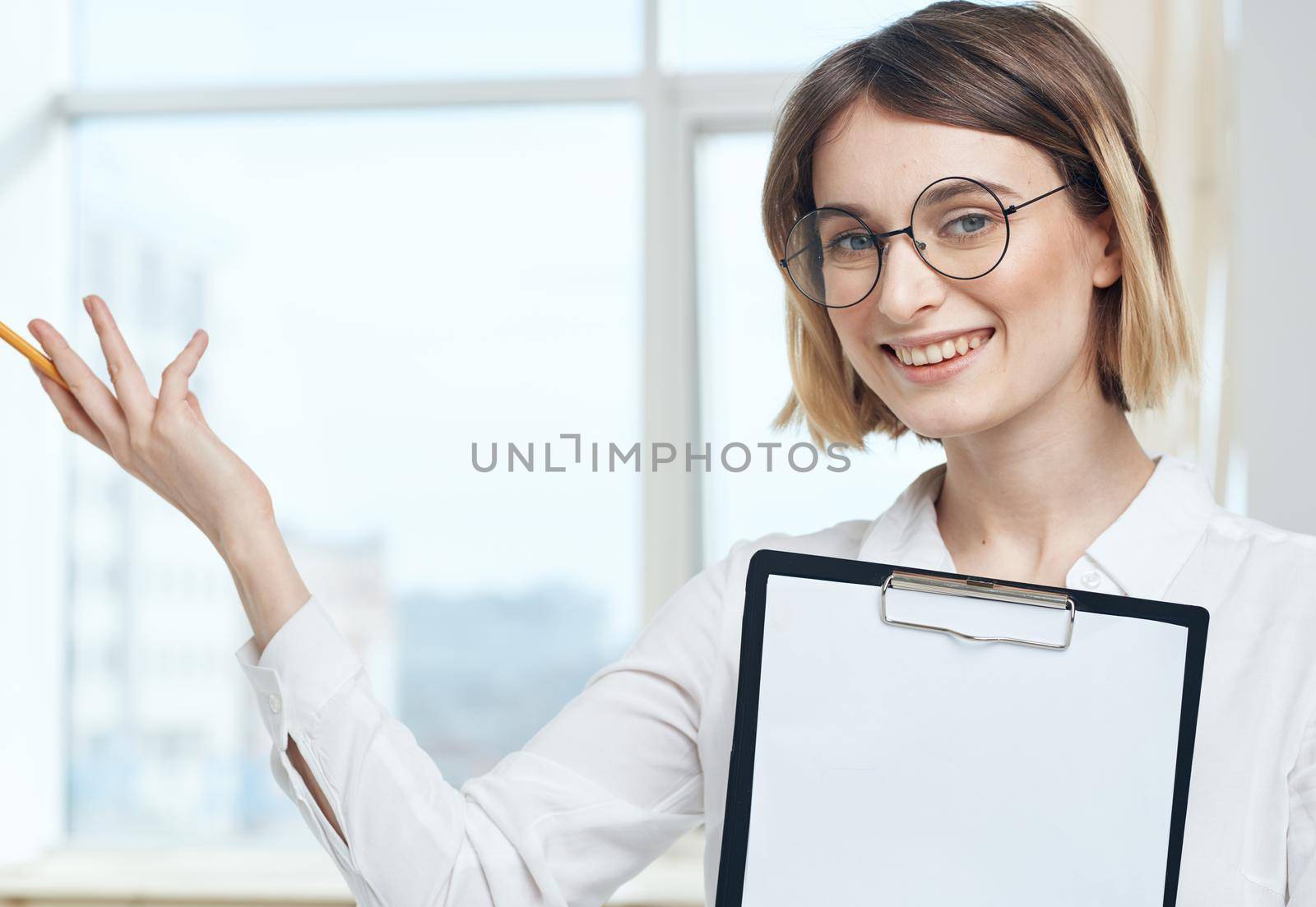 portrait of business woman with white sheet of paper in finance folder. High quality photo