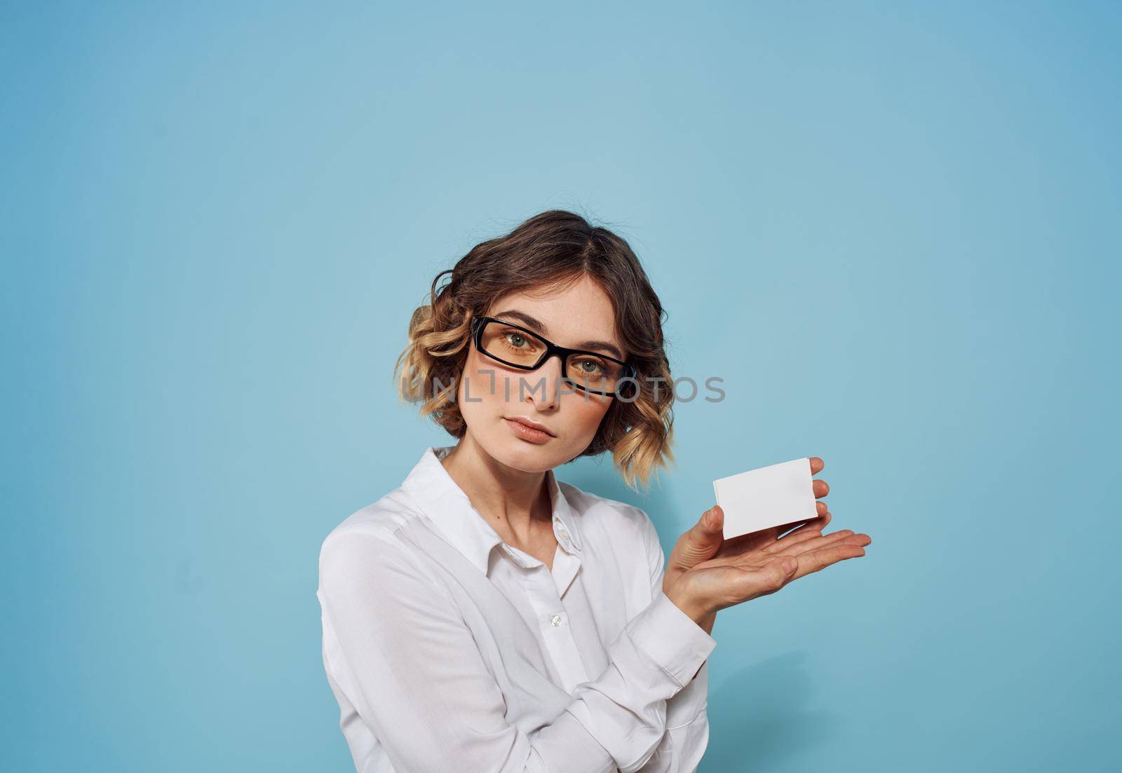 Shirtless business woman with a letterhead in her hands on a blue background mockup by SHOTPRIME