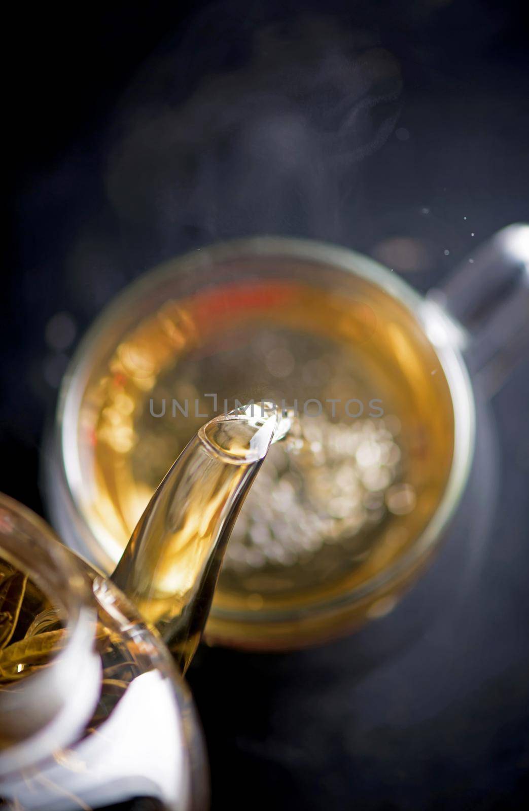 Tea concept, teapot with tea surrounded on wood background, tea ceremony, green tea in a transparent cup by aprilphoto