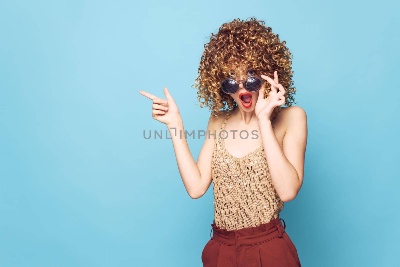 woman Surprised look hand gestures curly hair Studio Copy Space bright makeup close-up