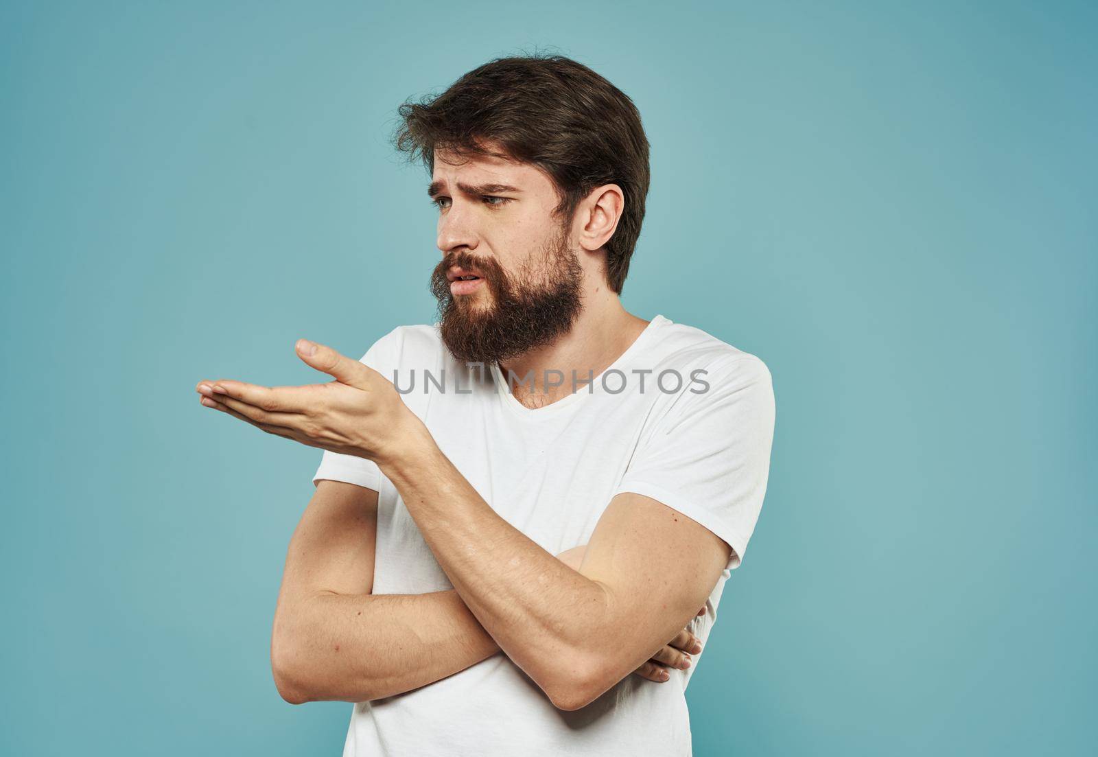 Man indignant look portrait emotions blue background model. High quality photo