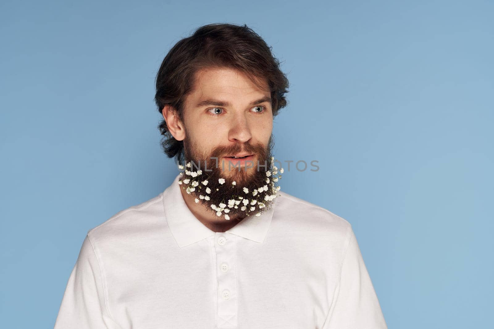 handsome man white shirt beard in colors emotions close-up blue background. High quality photo