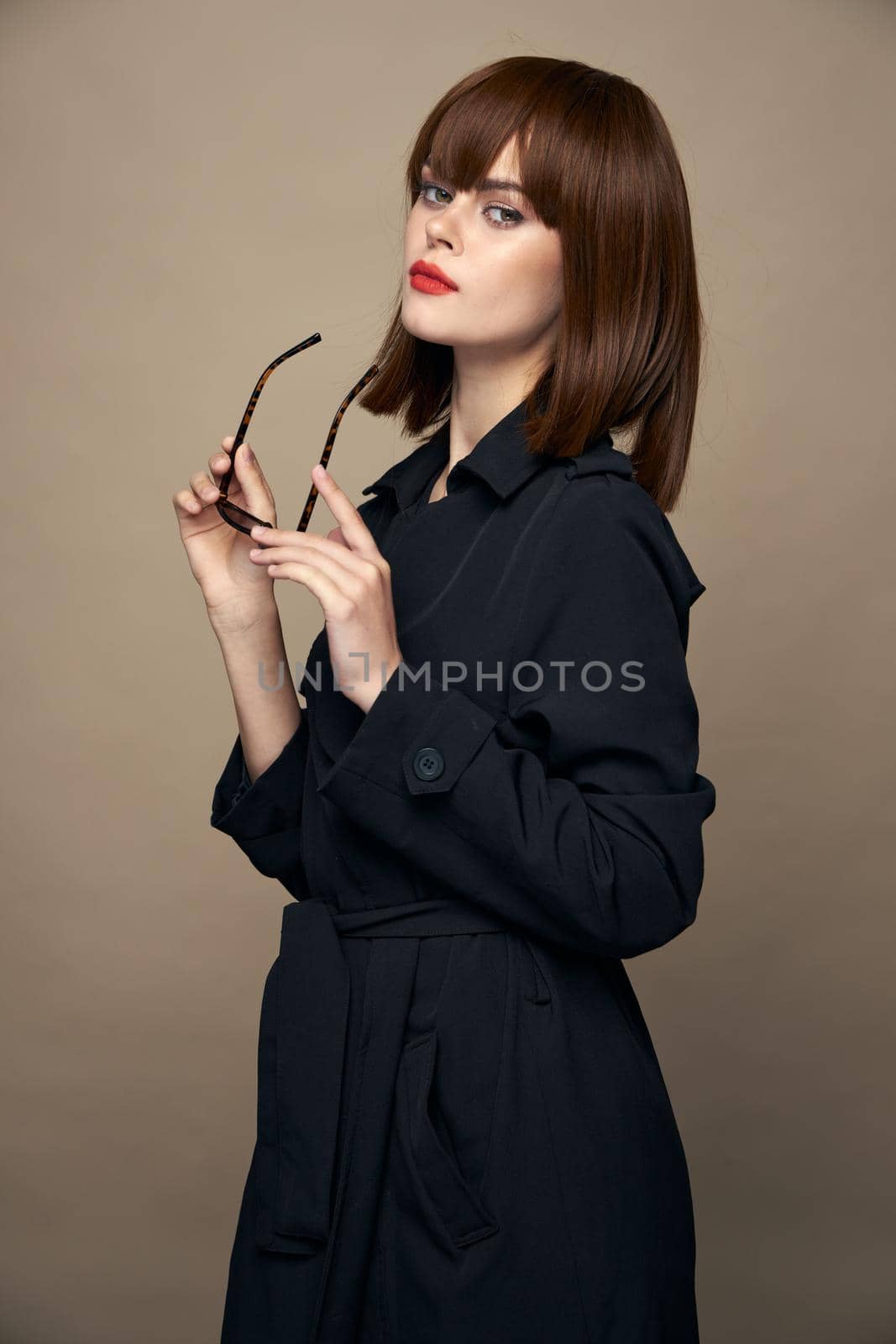 Pretty Woman holding glasses in his hands on isolated background red lips cropped view