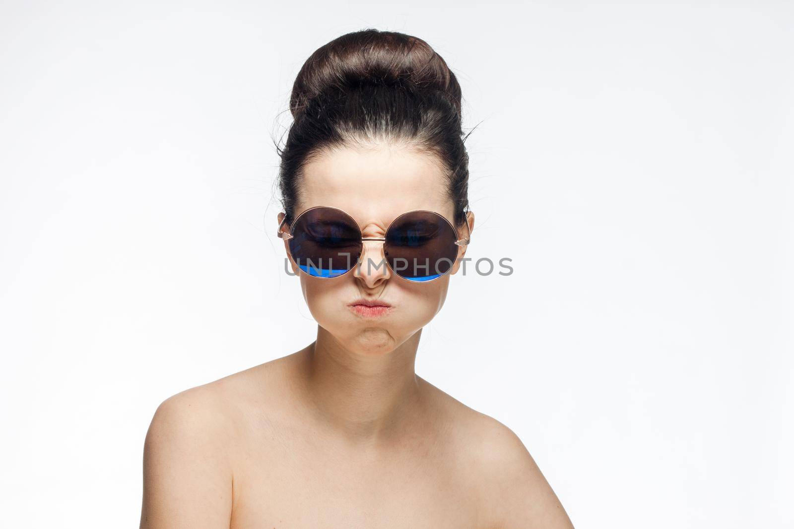 pretty woman naked shoulders and sunglasses light background fashion by SHOTPRIME