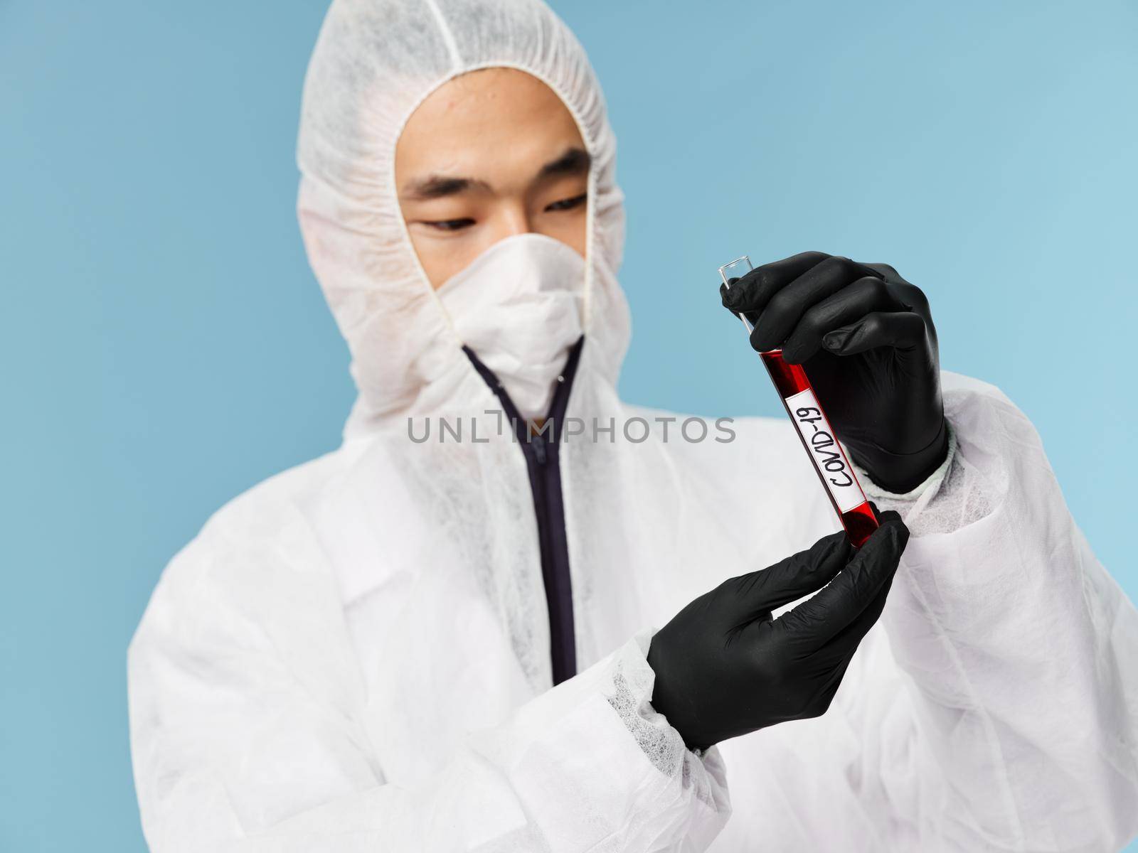 asian man blood test laboratory blue background close-up by SHOTPRIME