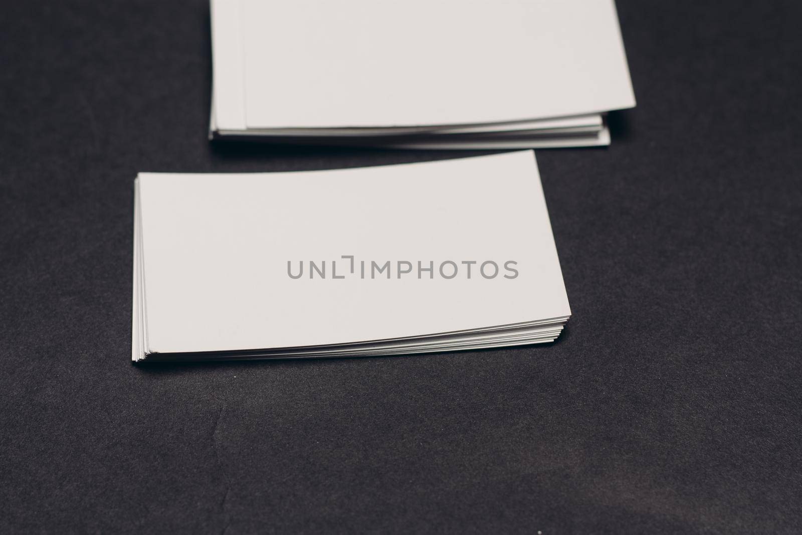 business cards on a dark table and a cup of coffee in the office work finance. High quality photo