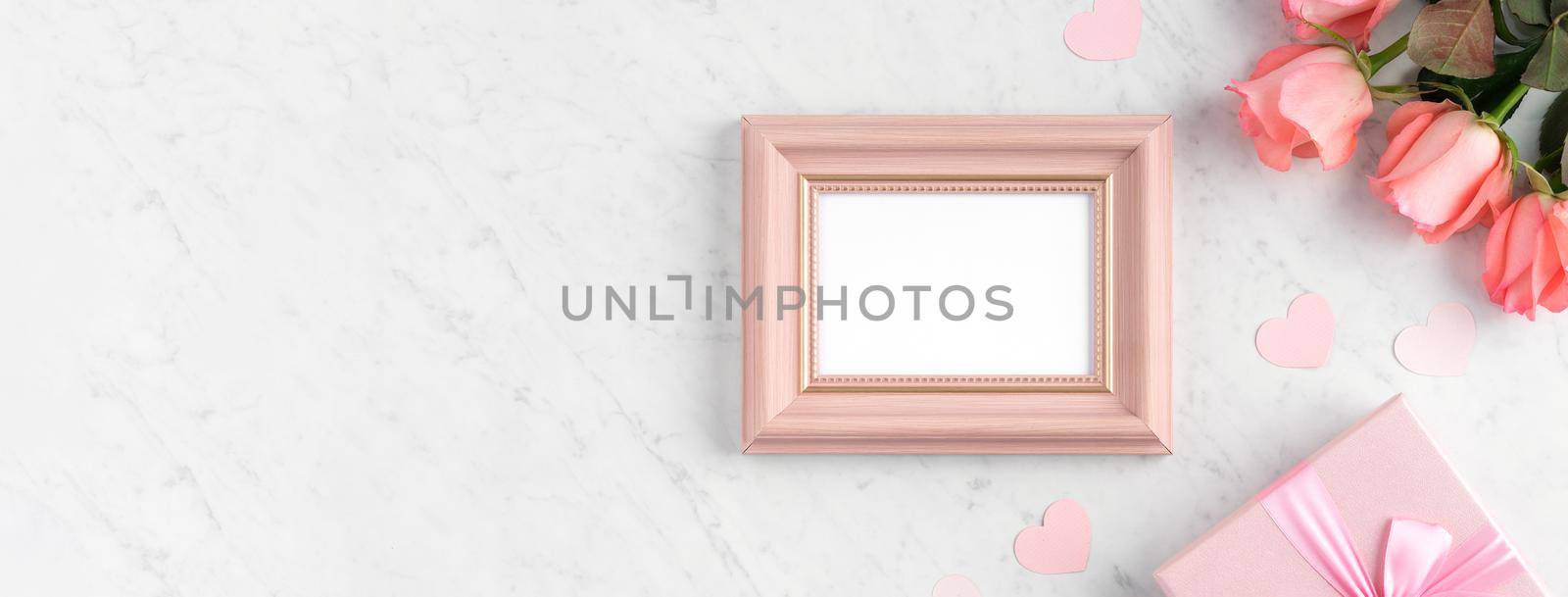 Giftbox and pink rose flower on marble white table background for Mother's Day holiday greeting design concept.