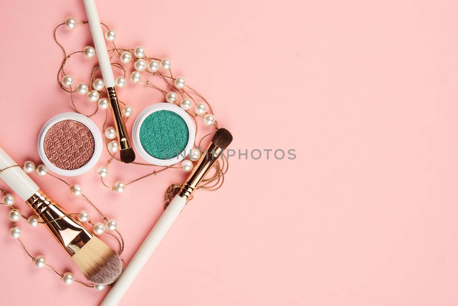 Female makeup decoration accessories on the table pink background top view by SHOTPRIME