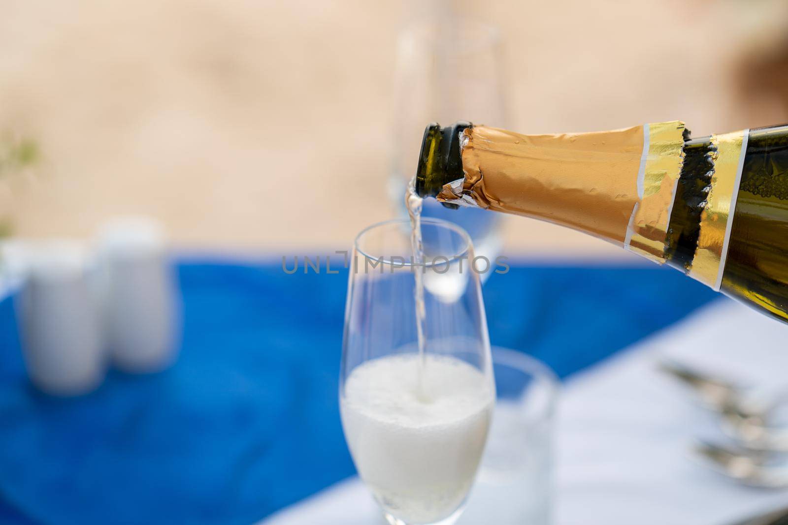 Close up : Bartender pouring champagne into glass. by sirawit99