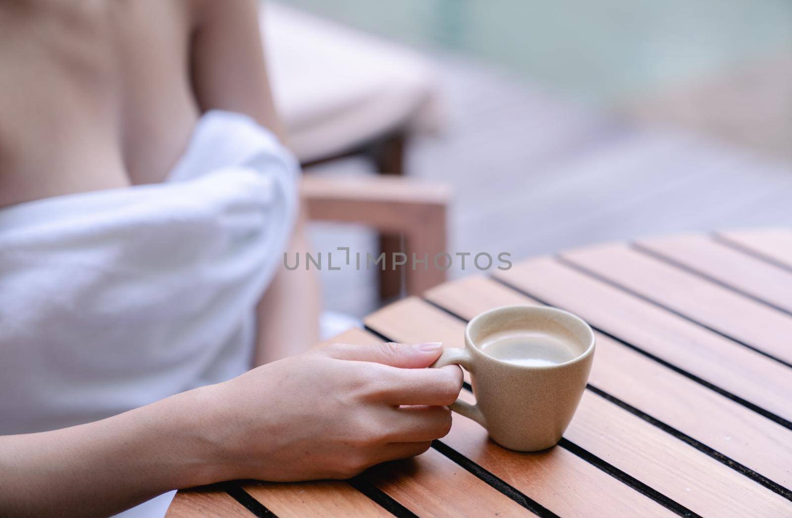 Close up of woman sexy breasts drinking with cup of coffee. Morning coffee.