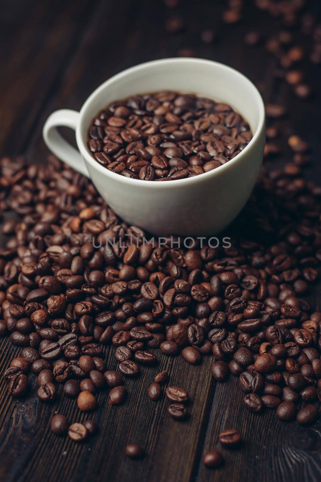 cup with coffee grains on a wooden table aromatic drink Arabica product. High quality photo