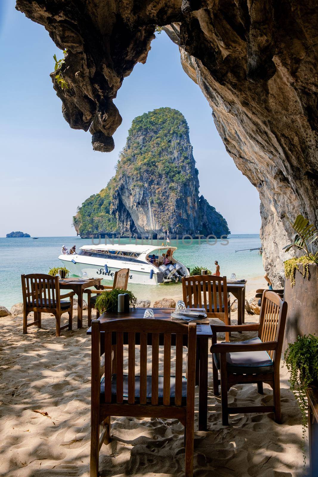 restaurant dinner tables or lunch on the beach Railay beach with a beautiful backdrop of Ko Rang Nok Island In Thailand Krabi. cliffs in Krabi on the beach