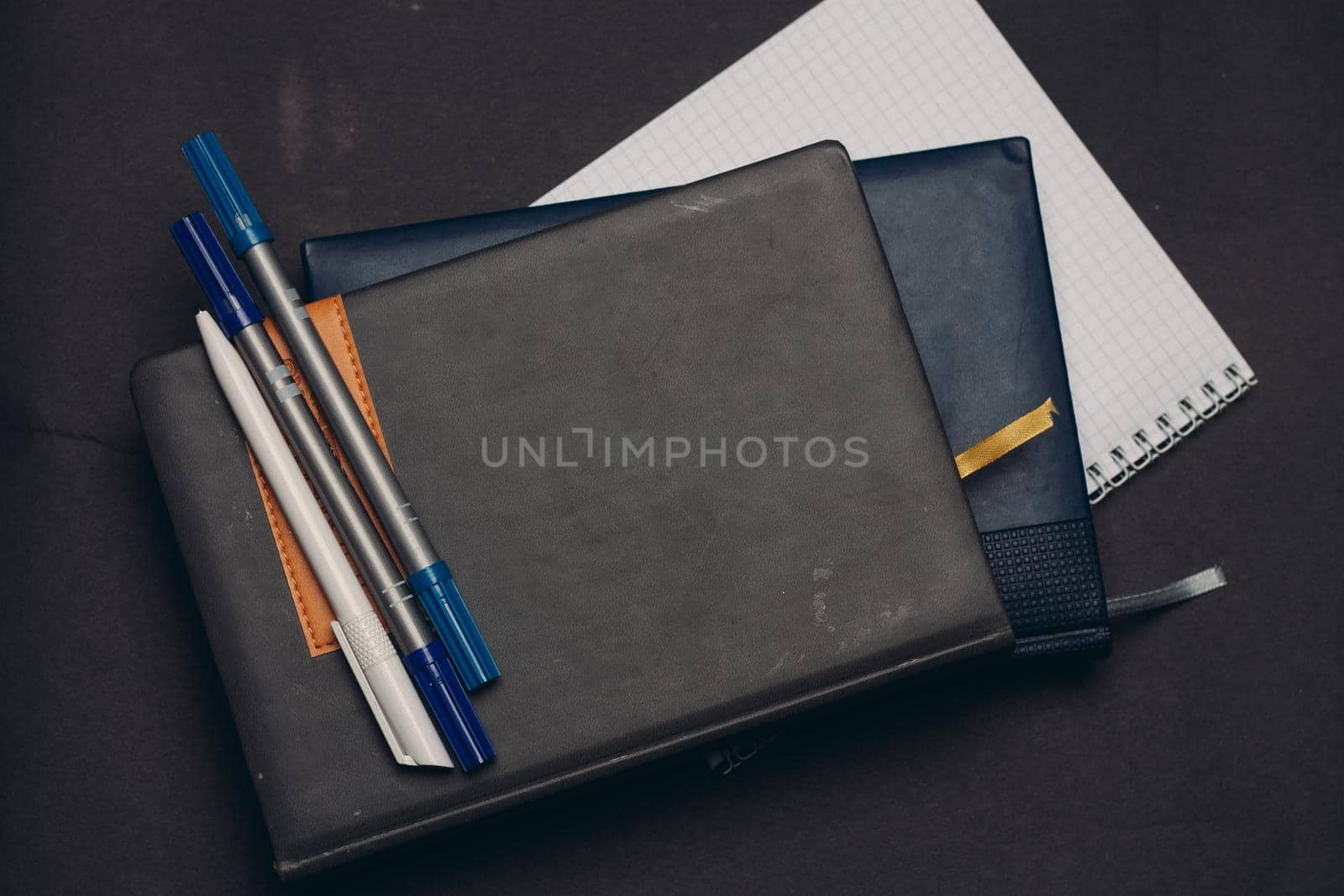 notepads documents desk pens office supplies gray background. High quality photo