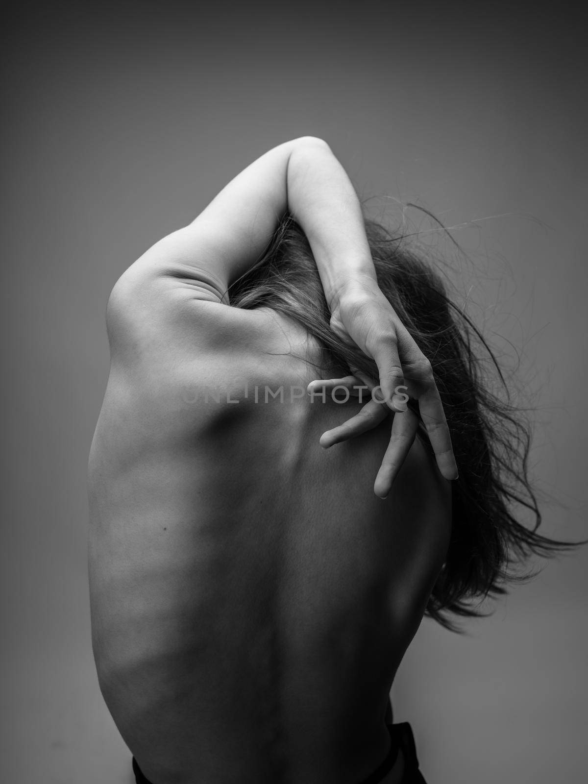 woman with naked back touching herself with hands on gray background cropped view by SHOTPRIME