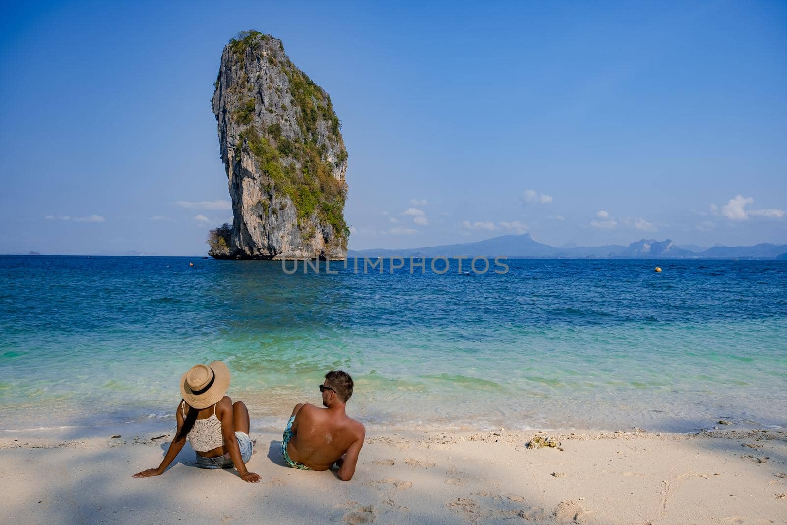 Koh Poda Island Thailand, couple mid age Asian woman and European man on the beach, Koh Poda Thailand, The beautiful tropical beach of Koh Poda or Poda Island in Krabi province of Thailand.  by fokkebok