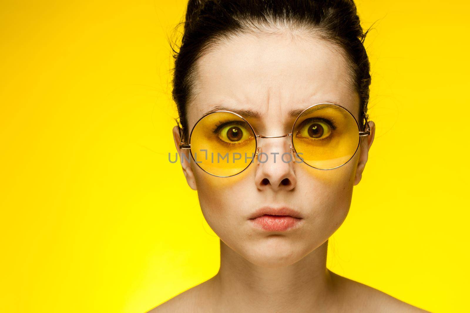 pretty woman with bare shoulders emotions fashionable yellow glasses cropped view by SHOTPRIME