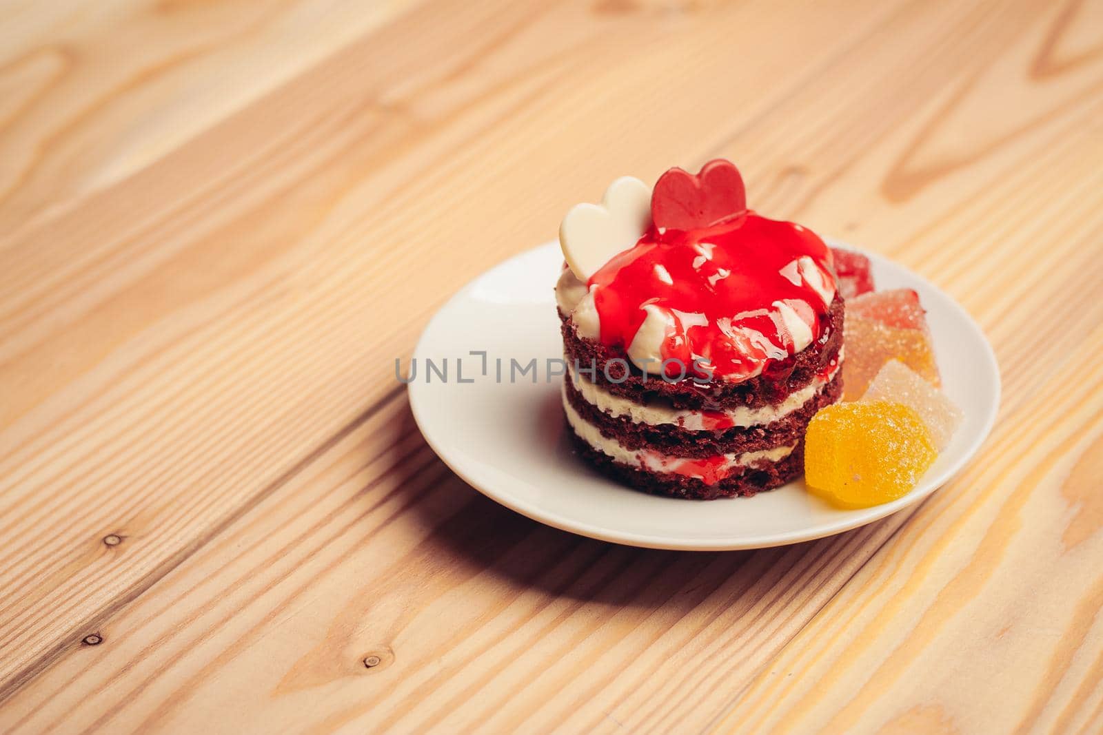 red cake street sweets marmalade tea cup wooden table dessert. High quality photo