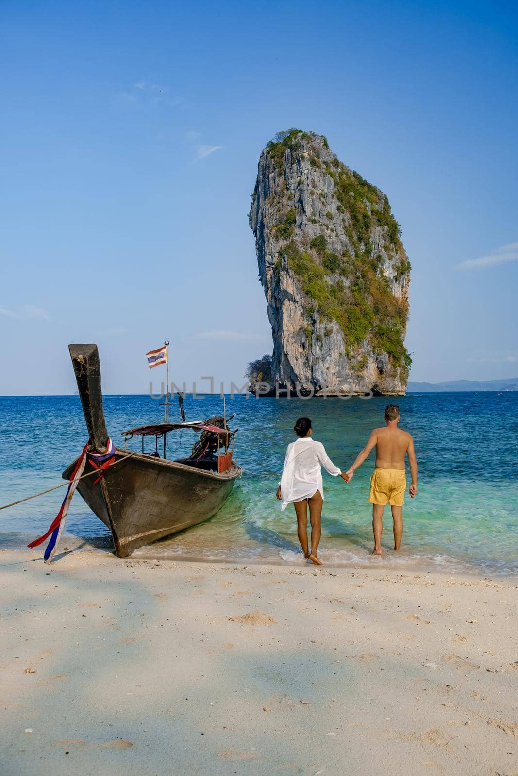 Koh Poda Island Thailand, couple mid age Asian woman and European man on the beach, Koh Poda Thailand, The beautiful tropical beach of Koh Poda or Poda Island in Krabi province of Thailand.  by fokkebok